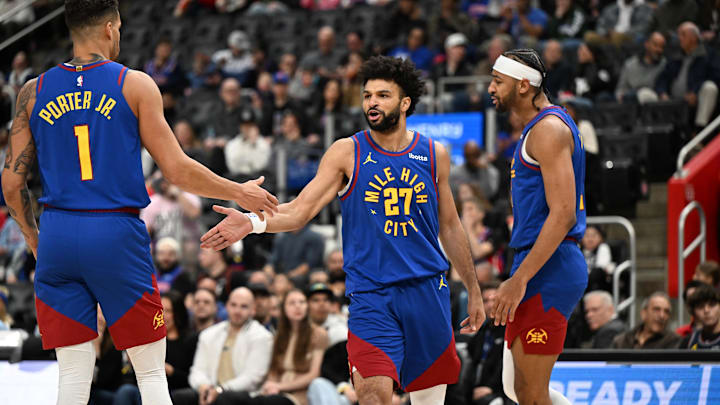 Feb 28, 2025; Detroit, Michigan, USA;  Denver Nuggets guard Jamal Murray (27) celebrates with forwards Michael Porter Jr. (1) and Zeke Nnaji (22) after scoring and drawing a foul against the Detroit Pistons in the first quarter at Little Caesars Arena. Mandatory Credit: Lon Horwedel-Imagn Images
