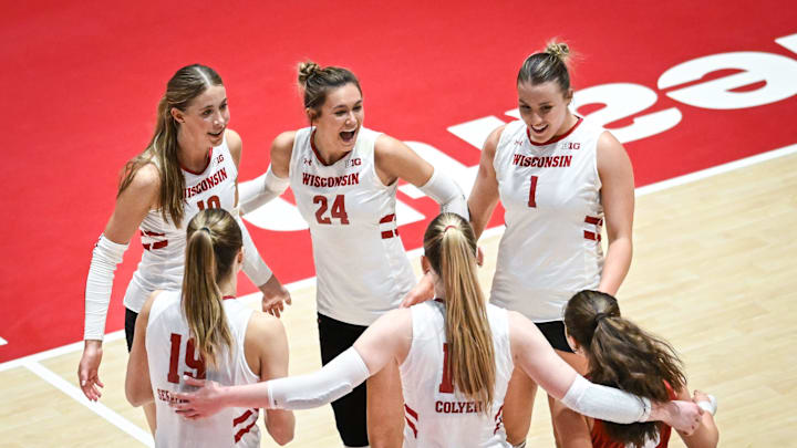 Wisconsin players Madison Quest (10), Charlie Fuerbringer (24), Ana Vajagic (1), Maile Chan (18), Mimi Colyer (15) and Tosia Serafinowska (19) celebrate match point against Marquette in a spring match Wednesday, April 16, 2025, at the UW Field House in Madison, Wisconsin.
