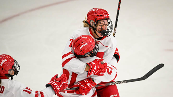 Wisconsin Badgers defender Emma Venusio (21) congratulates Wisconsin Badgers left wing Kelly Gorbatenko (7) on her goal against the Minnesota Gophers in the third period of a game Sunday, February 9, 2025, at LaBahn Arena in Madison, Wisconsin. UW won, 6-1.