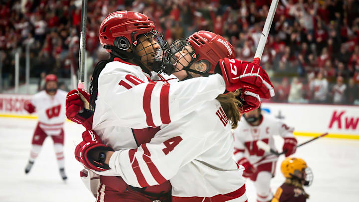 Wisconsin Badgers forward Laila Edwards, left, and defender Caroline Harvey celebrate after Edwards scored against the Minnesota Gophers in the first period in a game Saturday, February 8, 2025, at LaBahn Arena in Madison, Wisconsin.