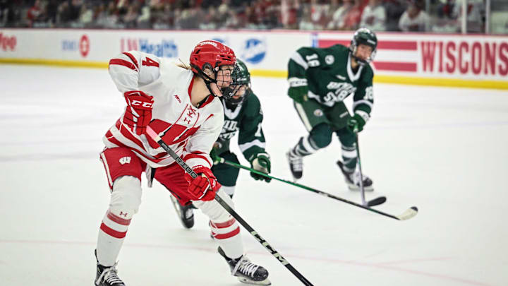 Wisconsin Badgers defender Caroline Harvey (4) makes a pass to set up a goal by Casey O'Brien (not seen) against the Bemidji State Beavers in the first period of a WCHA first-round game Saturday, March 1, 2025, at LaBahn Arena in Madison, Wisconsin.