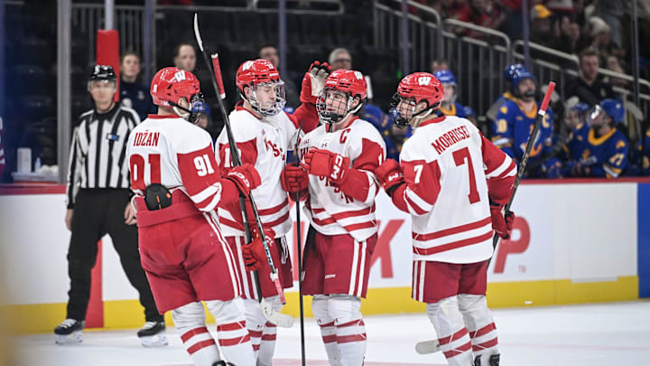 Teammates surround Wisconsin defenseman Ben Dexheimer (4) after this goal during the second period against Lake Superior State in a Kwik Trip Holiday Face-Off semifinal Sunday, December 28, 2025, at Fiserv Forum in MIlwaukee, Wisconsin. Teammates surround Wisconsin defenseman Ben Dexheimer (4) after this goal during the second period against Lake Superior State in a Kwik Trip Holiday Face-Off semifinal Sunday, December 28, 2025, at Fiserv Forum in MIlwaukee, Wisconsin.