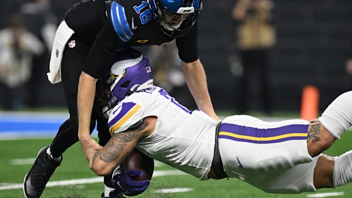 Jan 5, 2025; Detroit, Michigan, USA; Detroit Lions quarterback Jared Goff (16) tackles Minnesota Vikings linebacker Ivan Pace Jr. (0) after Pace intercepted Goff in the second quarter at Ford Field. Mandatory Credit: Lon Horwedel-Imagn Images