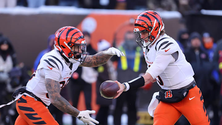 Dec 14, 2025; Cincinnati, Ohio, USA; Cincinnati Bengals quarterback Joe Burrow (9) hands off to running back Chase Brown (30) during the second quarter against the Baltimore Ravens at Paycor Stadium. Mandatory Credit: Joseph Maiorana-Imagn Images