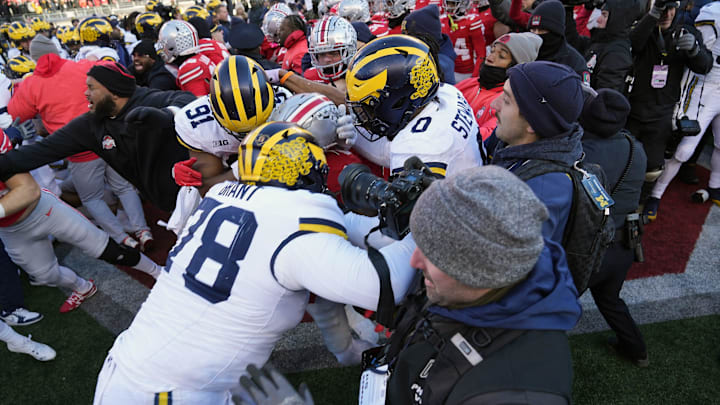 Michigan Wolverines defensive lineman Kenneth Grant (78) goes after Ohio State Buckeyes safety Jaylen McClain after the game during a fight at the middle of the field after the NCAA football game at Ohio Stadium in Columbus on Saturday, Nov. 30, 2024.
