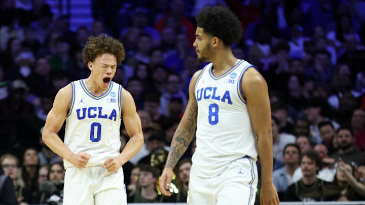 Mar 20, 2026; Philadelphia, PA, USA; UCLA Bruins guard Trent Perry (0) reacts with guard Eric Freeny (8) in the second half during a first round game of the men's 2026 NCAA Tournament at Xfinity Mobile Arena. Mandatory Credit: Bill Streicher-Imagn Images