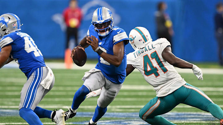 Detroit Lions quarterback Hendon Hooker (2) scrambles away from Miami Dolphins linebacker Channing Tidall (41) in the fourth quarter at Ford Field.