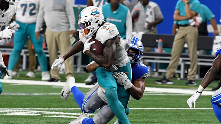 Miami Dolphins running back Ollie Gordon II (31) gets tackled by Detroit Lions linebacker Ezekiel Turner (47) in the fourth quarter at Ford Field.