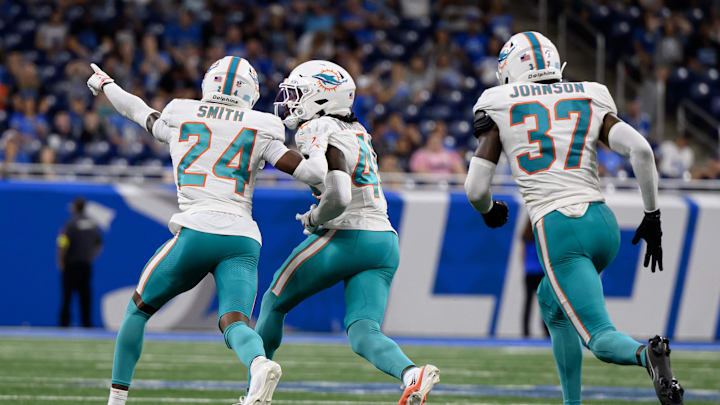 Miami Dolphins cornerback Ethan Robinson (46) celebrates with teammates Cam Smith (24) and Isaiah Johnson (37) after intercepting a pass against the Detroit Lions in the fourth quarter at Ford Field. Miami Dolphins cornerback Ethan Robinson (46) celebrates with teammates Cam Smith (24) and Isaiah Johnson (37) after intercepting a pass against the Detroit Lions in the fourth quarter at Ford Field.