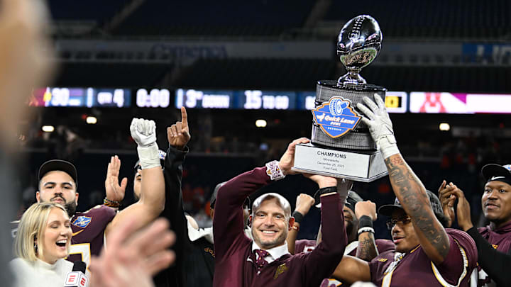 Dec 26, 2023; Detroit, MI, USA; Minnesota Golden Gophers running back Darius Taylor (1) and head coach P.J. Fleck hold up the Quick Lane Bowl trophy after defeating the Bowling Green Falcons at Ford Field. Mandatory Credit: Lon Horwedel-Imagn Images Dec 26, 2023; Detroit, MI, USA; Minnesota Golden Gophers running back Darius Taylor (1) and head coach P.J. Fleck hold up the Quick Lane Bowl trophy after defeating the Bowling Green Falcons at Ford Field. Mandatory Credit: Lon Horwedel-Imagn Images