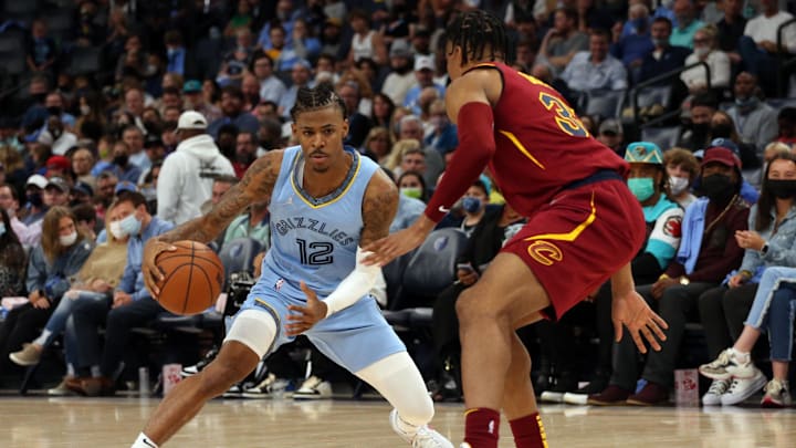  Memphis Grizzles guard Ja Morant (12) dribbles as Cleveland Cavaliers guard Isaac Okoro (35) defends during the second half at FedExForum. Mandatory Credit: Petre Thomas-Imagn Images