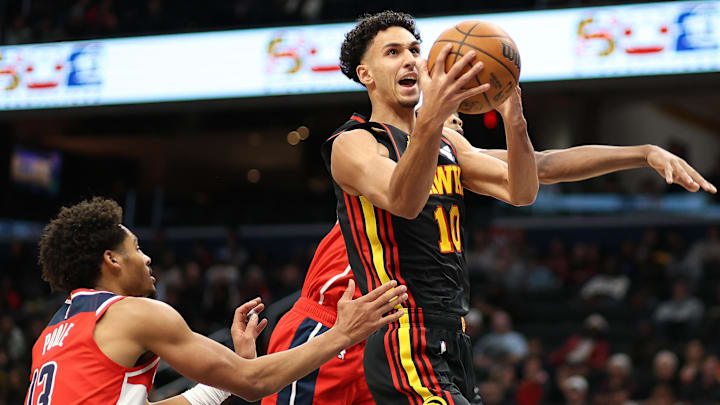 Feb 8, 2025; Washington, District of Columbia, USA; Atlanta Hawks forward Zaccharie Risacher (10) takes a shot over Washington Wizards guard Jordan Poole (13) during the first half at Capital One Arena. Mandatory Credit: Daniel Kucin Jr.-Imagn Images
