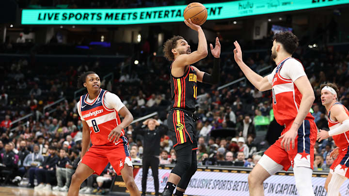 Feb 8, 2025; Washington, District of Columbia, USA; Atlanta Hawks guard Trae Young (11) takes a shot over Washington Wizards forward Tristan Vukcevic (00) during the first half at Capital One Arena. Mandatory Credit: Daniel Kucin Jr.-Imagn Images