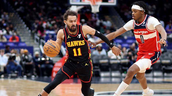 Feb 8, 2025; Washington, District of Columbia, USA; Atlanta Hawks guard Trae Young (11) drives past Washington Wizards guard Bilal Coulibaly (0) during the first half at Capital One Arena. Mandatory Credit: Daniel Kucin Jr.-Imagn Images