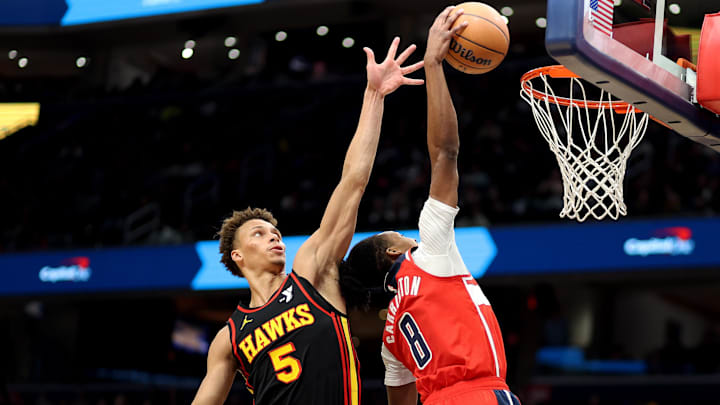 Feb 8, 2025; Washington, District of Columbia, USA; Washington Wizards guard Bub Carrington (8) dunks against Atlanta Hawks guard Dyson Daniels (5) during the second half at Capital One Arena. Mandatory Credit: Daniel Kucin Jr.-Imagn Images