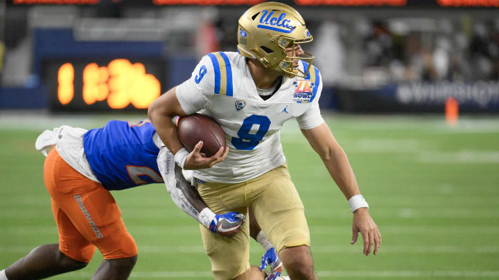 Dec 16, 2023; Inglewood, CA, USA; UCLA Bruins quarterback Collin Schlee (9) heads to the endzone against Boise State Broncos safety Seyi Oladipo (23) in the third quarter of the Starco Brands LA Bowl at SoFi Stadium. Mandatory Credit: Robert Hanashiro-USA TODAY Sports