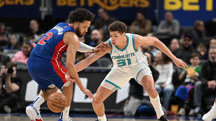 Feb 9, 2025; Detroit, Michigan, USA; Charlotte Hornets forward Tidjane Salaun (31) knocks the ball away from Detroit Pistons guard Cade Cunningham (2) in the third quarter at Little Caesars Arena. Mandatory Credit: Lon Horwedel-Imagn Images