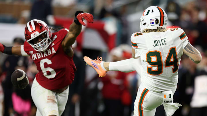Jan 19, 2026; Miami Gardens, FL, USA; Miami Hurricanes punter Dylan Joyce (94) has the punt blocked by Indiana Hoosiers defensive lineman Mikail Kamara (6) in the second half during the College Football Playoff National Championship game at Hard Rock Stadium. Mandatory Credit: Nathan Ray Seebeck-Imagn Images