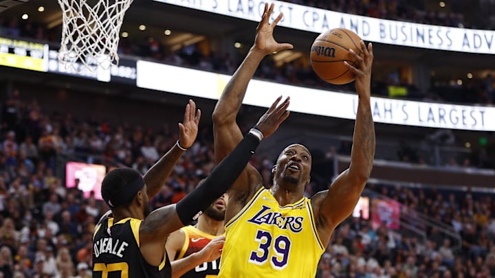 Mar 31, 2022; Salt Lake City, Utah, USA; Los Angeles Lakers center Dwight Howard (39) grabs a rebound against Utah Jazz forward Royce O'Neale (23) in the second quarter at Vivint Arena. Mandatory Credit: Jeffrey Swinger-Imagn Images