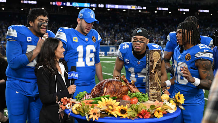 Detroit Lions offensive tackle Penei Sewell (58) admires CBS turkey after defeating Bears Detroit Lions offensive tackle Penei Sewell (58) admires CBS turkey after defeating Bears