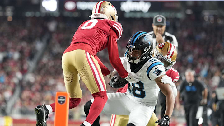 Nov 24, 2025; Santa Clara, California, USA; San Francisco 49ers cornerback Renardo Green (0) tackles Carolina Panthers wide receiver Jalen Coker (18) during the first half at Levi's Stadium. Mandatory Credit: Kyle Terada-Imagn Images