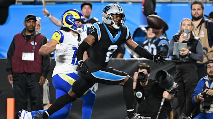 Jan 10, 2026; Charlotte, NC, USA; Los Angeles Rams wide receiver Puka Nacua (12) attempts to make a catch against Carolina Panthers cornerback Mike Jackson (2)  in the second half during the NFC Wild Card Round game at Bank of America Stadium. Mandatory Credit: Bob Donnan-Imagn Images