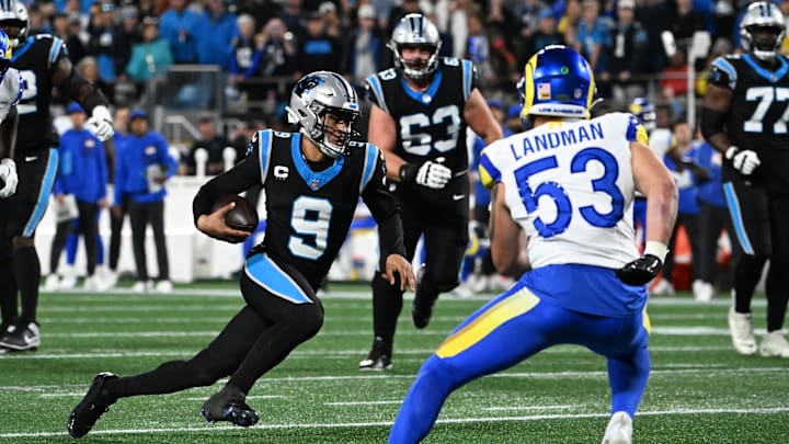 Jan 10, 2026; Charlotte, NC, USA;Carolina Panthers quarterback Bryce Young (9) rushes the ball against Los Angeles Rams linebacker Nate Landman (53) in the first half during the NFC Wild Card Round game at Bank of America Stadium. Mandatory Credit: Bob Donnan-Imagn Images