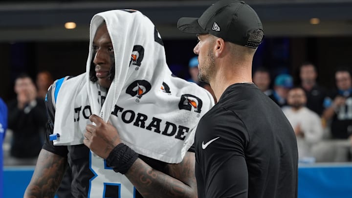 Carolina Panthers head coach Dave Canales and cornerback Jaycee Horn (8) react