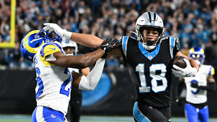 Jan 10, 2026; Charlotte, NC, USA; Carolina Panthers wide receiver Jalen Coker (18) makes a catch against Los Angeles Rams safety Kamren Kinchens (26) in the second half during the NFC Wild Card Round game at Bank of America Stadium. Mandatory Credit: Bob Donnan-Imagn Images Jan 10, 2026; Charlotte, NC, USA; Carolina Panthers wide receiver Jalen Coker (18) makes a catch against Los Angeles Rams safety Kamren Kinchens (26) in the second half during the NFC Wild Card Round game at Bank of America Stadium. Mandatory Credit: Bob Donnan-Imagn Images
