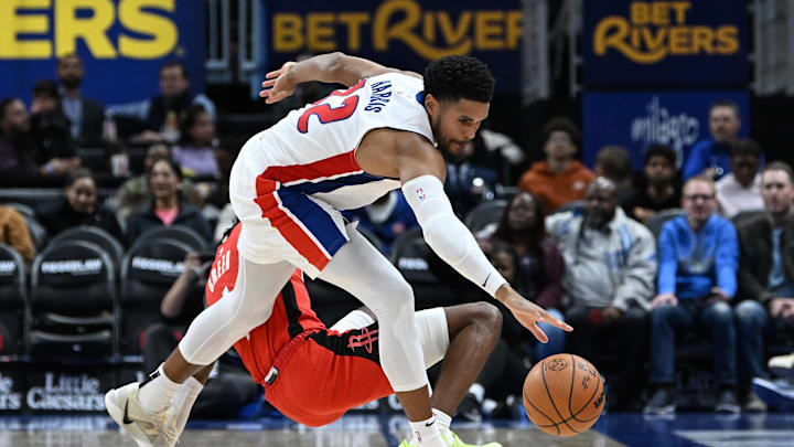 Nov 10, 2024; Detroit, Michigan, USA; Detroit Pistons forward Tobias Harris (12) battles for a loose ball against Houston Rockets guard Jalen Green (4) in the third quarter at Little Caesars Arena. Mandatory Credit: Lon Horwedel-Imagn Images