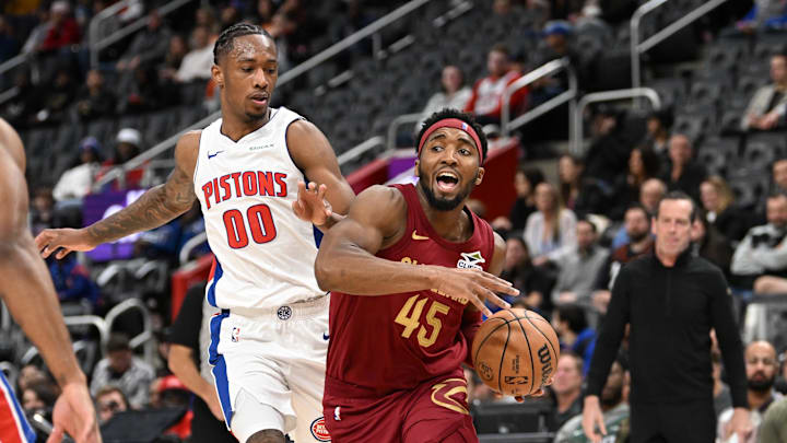 Oct 16, 2024; Detroit, Michigan, USA; Cleveland Cavaliers guard Donovan Mitchell (45) drives to the basket past Detroit Pistons forward Ron Holland II (00) in the second quarter at Little Caesars Arena. Mandatory Credit: Lon Horwedel-Imagn Images