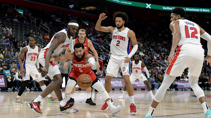 Nov 10, 2024; Detroit, Michigan, USA;  Houston Rockets guard Fred VanVleet (5) battles for a loose ball with Detroit Pistons forward Paul Reed (7) and guard Cade Cunningham (2) in the second quarter at Little Caesars Arena. Mandatory Credit: Lon Horwedel-Imagn Images