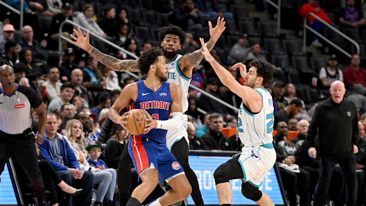 Mar 11, 2024; Detroit, Michigan, USA;   Detroit Pistons guard Cade Cunningham (2) is double teamed by Charlotte Hornets guard Vasilije Micic (22) and center Nick Richards (4) in the first quarter at Little Caesars Arena. Mandatory Credit: Lon Horwedel-Imagn Images