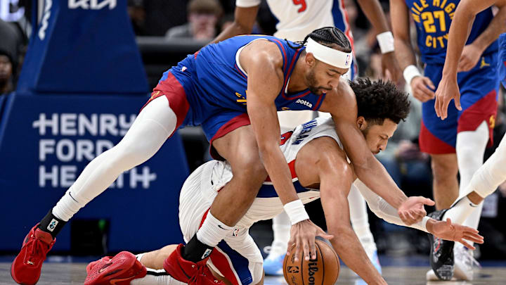 Feb 28, 2025; Detroit, Michigan, USA;  Denver Nuggets forward Zeke Nnaji (22) and Detroit Pistons guard Cade Cunningham (2) battle for a loose ball in the first quarter at Little Caesars Arena. Mandatory Credit: Lon Horwedel-Imagn Images