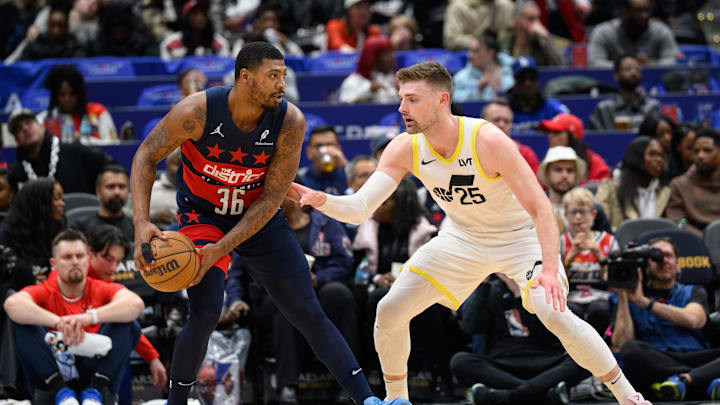 Mar 5, 2025; Washington, District of Columbia, USA; Washington Wizards guard Marcus Smart (36) looks to pass the ball against Utah Jazz center Micah Potter (25) during the fourth quarter at Capital One Arena. Mandatory Credit: Reggie Hildred-Imagn Images