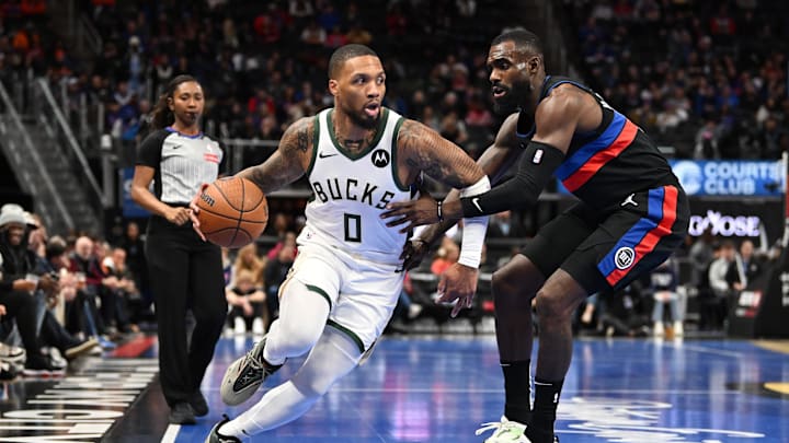 Dec 3, 2024; Detroit, Michigan, USA; Milwaukee Bucks guard Damian Lillard (0) controls the ball against Detroit Pistons forward Tim Hardaway Jr. (8) in the first quarter at Little Caesars Arena. Mandatory Credit: Lon Horwedel-Imagn Images Dec 3, 2024; Detroit, Michigan, USA; Milwaukee Bucks guard Damian Lillard (0) controls the ball against Detroit Pistons forward Tim Hardaway Jr. (8) in the first quarter at Little Caesars Arena. Mandatory Credit: Lon Horwedel-Imagn Images