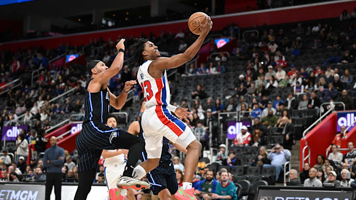 Jan 1, 2025; Detroit, Michigan, USA; Detroit Pistons guard Jaden Ivey (23) drives past Orlando Magic guard Jalen Suggs (4) in the third quarter at Little Caesars Arena. Mandatory Credit: Lon Horwedel-Imagn Images