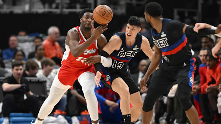Apr 5, 2025; Detroit, Michigan, USA;  Memphis Grizzlies forward Jaren Jackson Jr. (13) and Detroit Pistons forward Simone Fontecchio (19) battle for a loose ball in the second quarter at Little Caesars Arena. Mandatory Credit: Lon Horwedel-Imagn Images