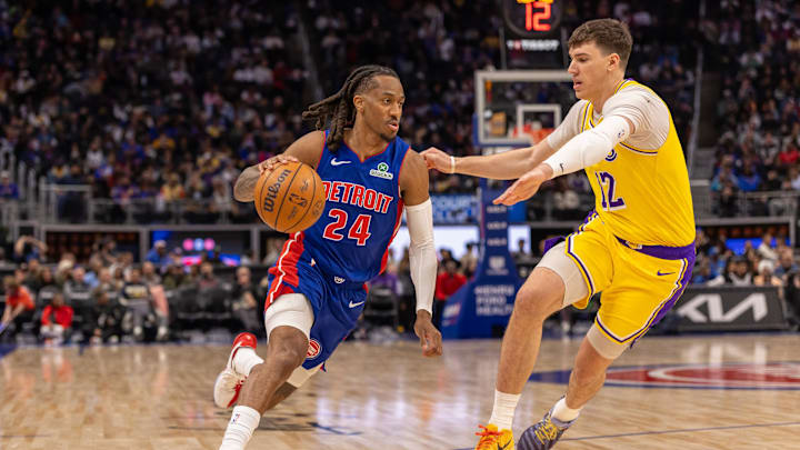Mar 23, 2026; Detroit, Michigan, USA; Los Angeles Lakers Jake LaRavia (12) defends against Detroit Pistons Daniss Jenkins (24) during the second half at Little Caesars Arena. Mandatory Credit: David Reginek-Imagn Images
