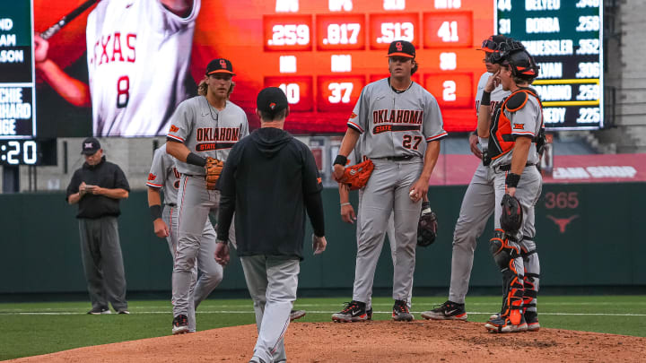Oklahoma State head coach Josh Holliday approaches the mound to talk to pitcher Sam Garcia (27) during the game against the Texas Longhorns at UFCU Disch–Falk Field on Friday, May. 3, 2024 in Austin. Oklahoma State head coach Josh Holliday approaches the mound to talk to pitcher Sam Garcia (27) during the game against the Texas Longhorns at UFCU Disch–Falk Field on Friday, May. 3, 2024 in Austin.