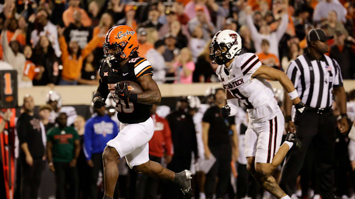Oklahoma State's Rodney Fields Jr. runs for a touchdown against Texas Tech's C.J. Baskerville during an NCAA football game on Saturday, Nov. 23, 2024, in Stillwater, Okla. Oklahoma State's Rodney Fields Jr. runs for a touchdown against Texas Tech's C.J. Baskerville during an NCAA football game on Saturday, Nov. 23, 2024, in Stillwater, Okla.