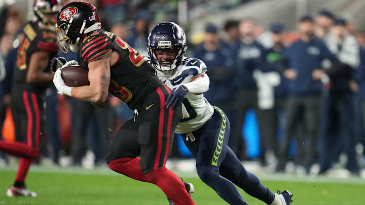 Jan 3, 2026; Santa Clara, California, USA; Seattle Seahawks safety Julian Love (20) tackles San Francisco 49ers running back Christian McCaffrey (23) during the second half at Levi's Stadium. Mandatory Credit: Neville E. Guard-Imagn Images Jan 3, 2026; Santa Clara, California, USA; Seattle Seahawks safety Julian Love (20) tackles San Francisco 49ers running back Christian McCaffrey (23) during the second half at Levi's Stadium. Mandatory Credit: Neville E. Guard-Imagn Images