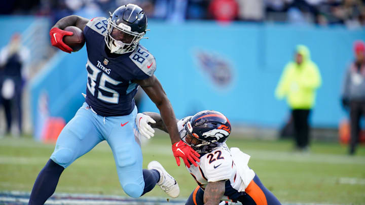 Tennessee Titans tight end Chigoziem Okonkwo gets away from Denver Broncos safety Kareem Jackson.