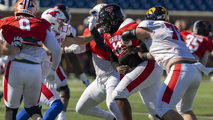 Texas Tech defensive tackle Lee Hunter gets inside block by Iowa's Beau Stephens in Senior Bowl practice.