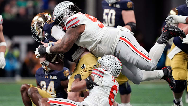 Ohio State Buckeyes safety Sonny Styles (6) and defensive tackle Tyleik Williams (91) sacks Notre Dame Fighting Irish quarterback Riley Leonard (13) in the third quarter during the College Football Playoff championship