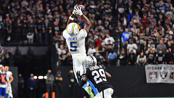 Jan 9, 2022; Paradise, Nevada, USA;Los Angeles Chargers wide receiver Josh Palmer (5) attempts catch a pass as Las Vegas Raiders cornerback Casey Hayward (29) defends during the fourth quarter at Allegiant Stadium