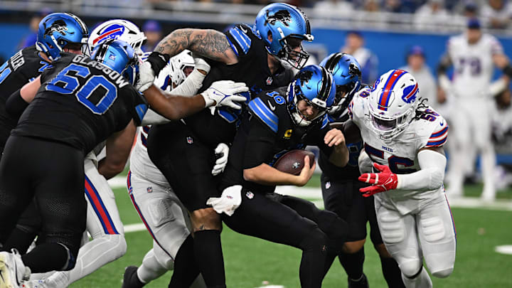 Dec 15, 2024; Detroit, Michigan, USA; Detroit Lions quarterback Jared Goff (16) ducks out of a sack attempt by Buffalo Bills defensive end Javon Solomon (56) in the fourth quarter at Ford Field.