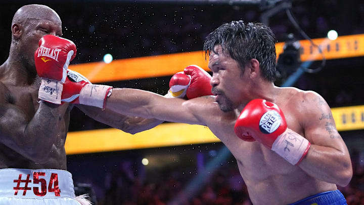 Manny Pacquiao (right) fights Yordenis Ugas in a world welterweight championship bout at T-Mobile Arena. 