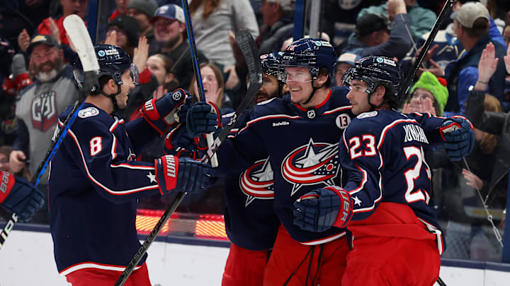 Jan 4, 2025; Columbus, Ohio, USA;  Columbus Blue Jackets left wing Dmitri Voronkov (center) celebrates his goal with center Sean Monahan (23) and defenseman Zach Werenski (8) during the first period against the St. Louis Blues at Nationwide Arena. Mandatory Credit: Joseph Maiorana-Imagn Images