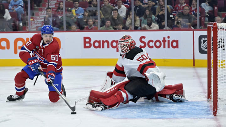 Sep 24, 2024; Montreal, Quebec, CAN; New Jersey Devils goalie Nico Daws (50) stops Montreal Canadiens forward Florian Xhekaj (60) during the third period at the Bell Centre. Mandatory Credit: Eric Bolte-Imagn Images